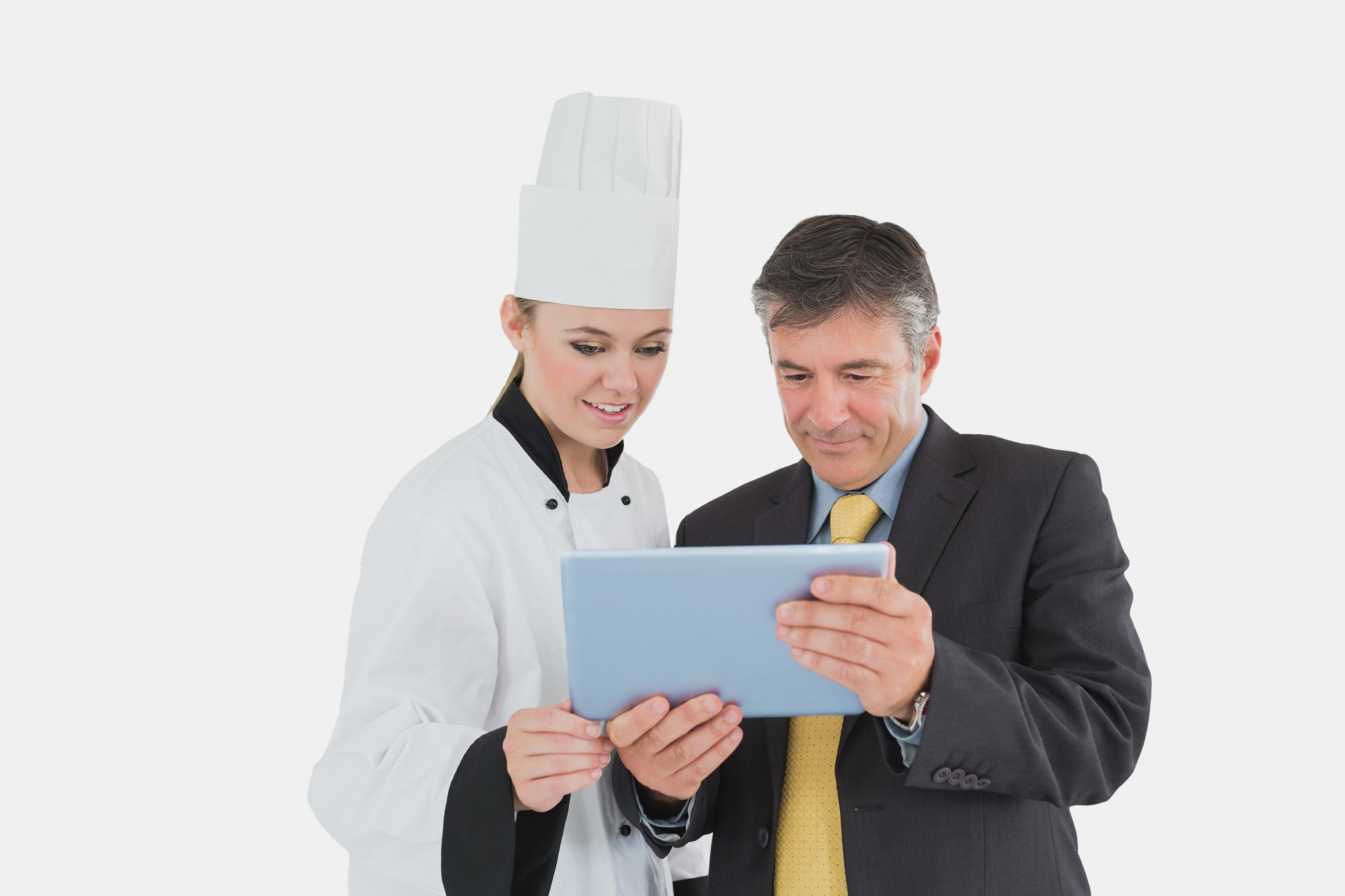 chef consulting with manager over tablet